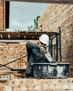 Laborer working with cement at a construction site