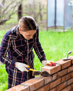 Woman working with bricks at a construction site