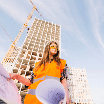 Woman standing near a building under construction at a construction site