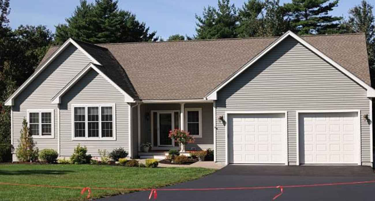 Smooth finished asphalt driveway in suburban home illustrating asphalt driveway cost and durability
